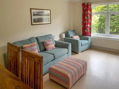 a living room with a couch and a chair at La'al Gem in Keswick