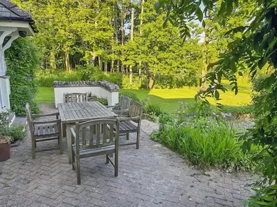 a wooden table and chairs in a garden at Overwater Lodge in Bassenthwaite Lake