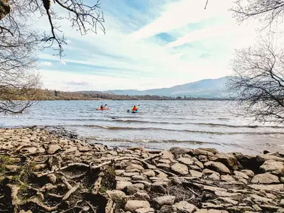 two people are kayaking on a large lake at Osprey Cottage in Bassenthwaite