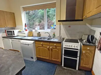 a kitchen with a sink and a stove top oven at Oak Lea in Braithwaite