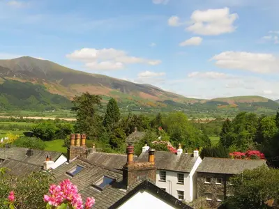 a view of a village with mountains in the background at The Larches in Braithwaite