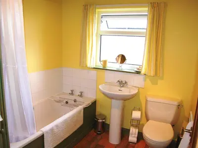 a bathroom with a sink and a tub and a toilet at Beech End in Braithwaite