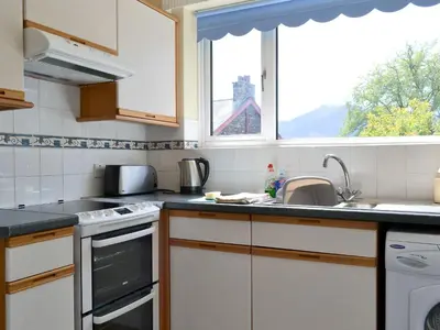 a kitchen with a sink and a window at Whitegates in Portinscale