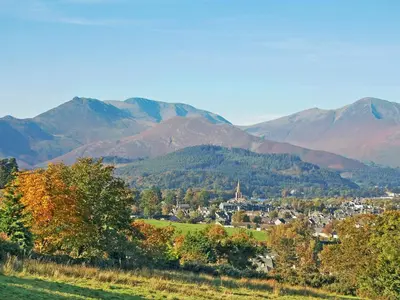 a town in a valley with mountains in the background at Whitegates in Portinscale