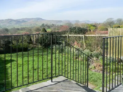 a wrought iron fence with a view of a garden at Cropple Howe in Threlkeld