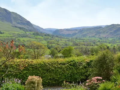 a view of a valley with mountains in the distance at Cropple Howe in Threlkeld