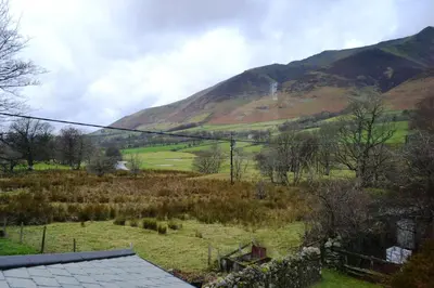 a view of a field with a mountain in the background at Netherend in Threlkeld