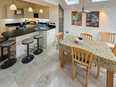 a kitchen and dining room with a table and chairs at Brasscam in Rosthwaite