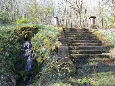 a set of stone stairs next to a waterfall at The Old Stables in Uldale