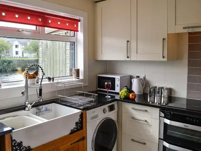 a kitchen with a sink and a dishwasher at Minnow Cottage in Newton Stewart