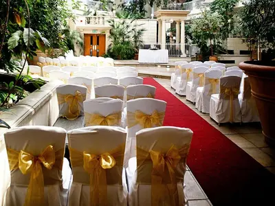 a row of white chairs with bows on them at The Sefton in Douglas