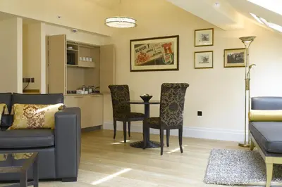 a living room with a couch and a table and chairs at The Sefton in Douglas