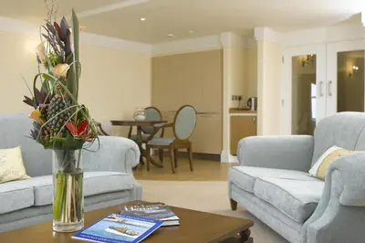 a living room with a vase of flowers on a table at The Sefton in Douglas