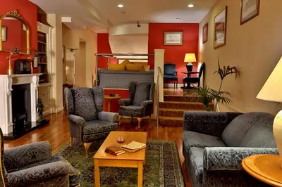 a living room with couches and a bed at The Sefton in Douglas
