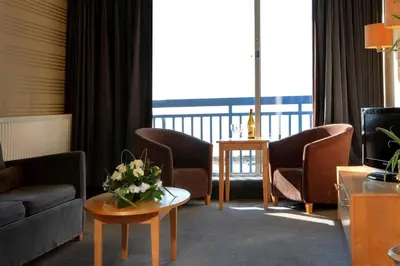 a living room with a couch and chairs and a table at Best Western Palace Hotel & Casino in Douglas