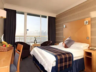 a hotel room with a bed and a large window at Best Western Palace Hotel & Casino in Douglas