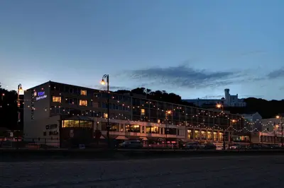 a building at night with cars parked in front of it at Best Western Palace Hotel & Casino in Douglas