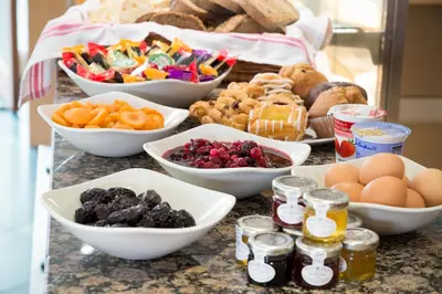 a table topped with bowls of fruit and other foods at The Lodge In The Vale in Thirlmere