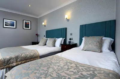 a hotel room with two beds and two pillows at The Farmers Inn in Dumfries