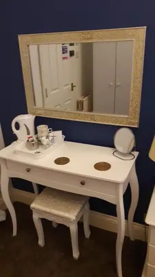 a bathroom with a white sink and a mirror at Blueberry Two Bedroom Suite for 1, 2 or 3 people in Douglas