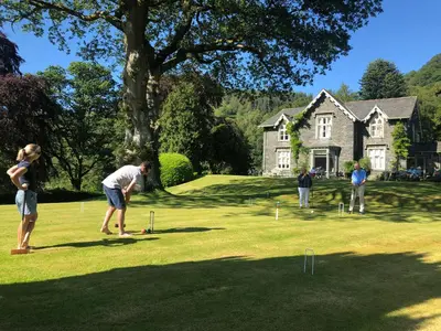 a group of people playing a game of mini golf at Hazel Bank Country House Borrowdale Valley in Rosthwaite