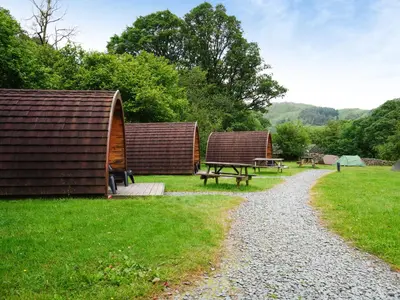 a couple of huts and a picnic table in a park at YHA Borrowdale in Rosthwaite