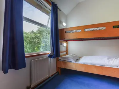 a bedroom with a bunk bed and a window at YHA Borrowdale in Rosthwaite