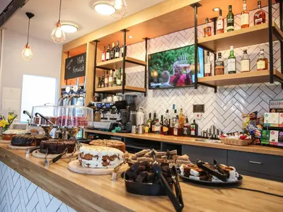 a bakery counter with a cake on a table at YHA Keswick in Keswick