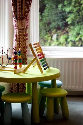 a table and two stools with a toy on it at YHA Grasmere Butharlyp Howe in Grasmere