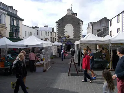 a group of people walking around a market with tents at Swiss Court Guest House in Keswick