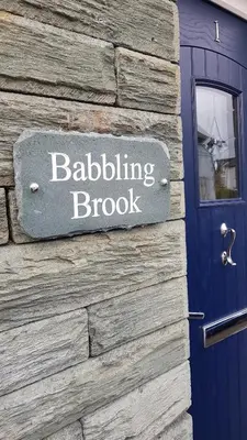 a sign on the side of a building that reads building brook at Babbling Brook Guesthouse in Keswick