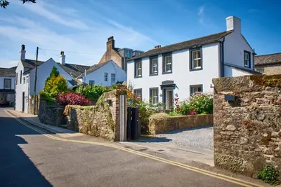 a row of white houses on a street at Trout Hotel in Cockermouth
