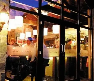 a group of people sitting at a counter in a restaurant at Trout Hotel in Cockermouth