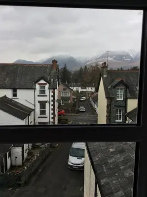 a view from a window of a town with mountains at Dolly Waggon Guest House in Keswick