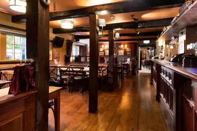 a restaurant with a bar and a tables and chairs at The Pheasant Inn - The Inn Collection Group in Bassenthwaite