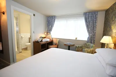 a hotel room with a bed and a bathroom at The Pheasant Inn - The Inn Collection Group in Bassenthwaite