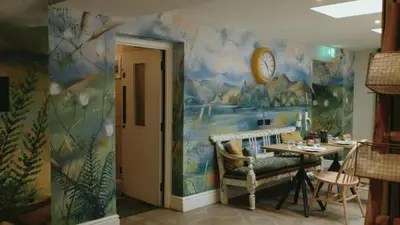 a dining room with a table and a clock on a wall at Royal Oak Hotel in Rosthwaite