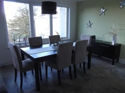 a dining room with a table and chairs at At Cedar Lodge in Ramsey