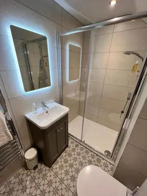 a bathroom with a sink and a shower and a toilet at The Ruddings in Keswick