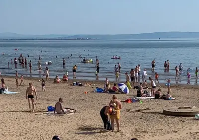 a large group of people on a beach at Harbourlights Accomodation in Irvine