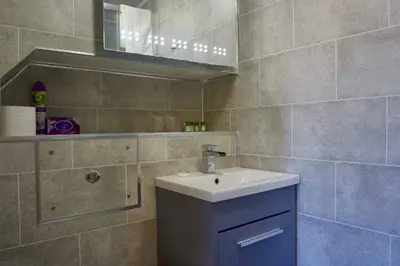 a bathroom with a sink and a mirror at Greystoke House in Keswick