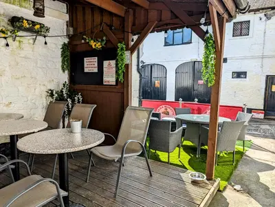 a patio with tables and chairs at a restaurant at Graham Arms Inn in Longtown