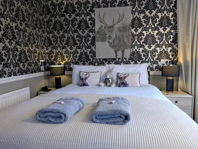 a bedroom with a bed with towels on it at Graham Arms Inn in Longtown