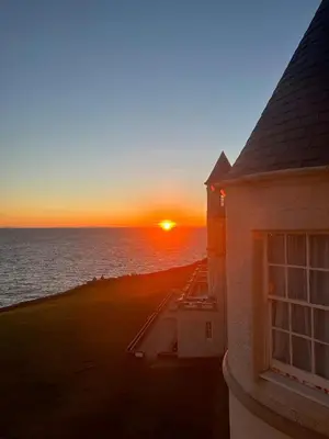 a sunset from the balcony of a house at The Portpatrick Hotel by Compass Hospitality in Portpatrick
