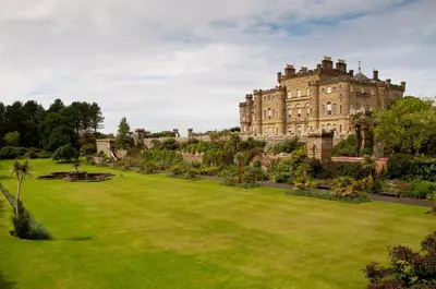 an image of a large lawn in front of a castle at Woodcroft Cottage in Ayr