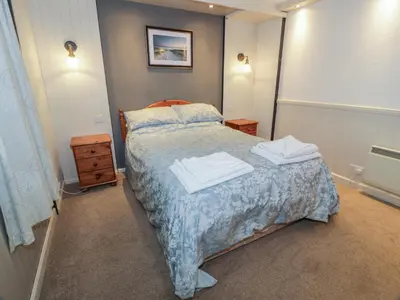 a bedroom with a bed with two towels on it at Kouloura in Mainsriddle