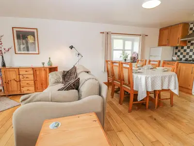 a living room with a table and a couch at Bleng Barn Cottage in Seascale