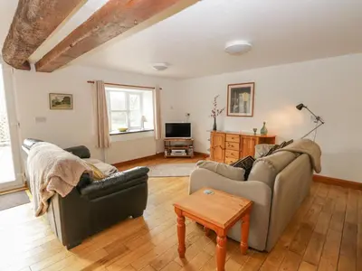 a living room with two couches and a tv at Bleng Barn Cottage in Seascale