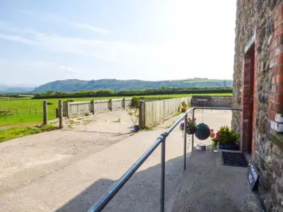 a brick building with a view of a field at Muncaster View in Drigg