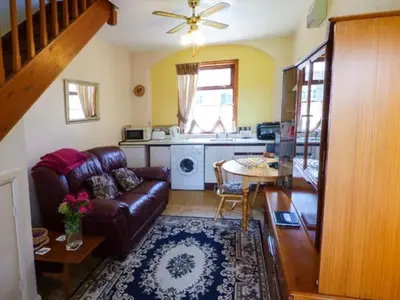 a living room with a couch and a table at Gable View in Drigg